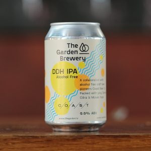 The Garden Brewery can of non-alcoholic DDH IPA brewed in collab with Coast. Cream label with watercoloured yellow and orange dots and blue diagonal curved lines.